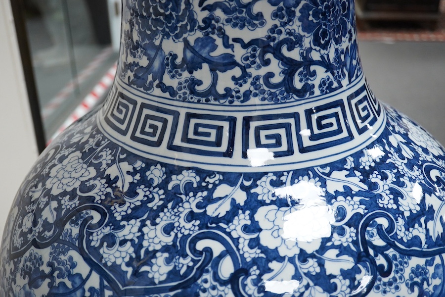 A massive Chinese blue and white floor standing baluster vase, decorated with peonies and foliage, 120cm high. Condition - good